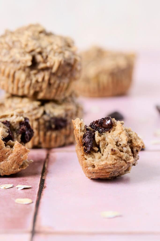 pb banana baked oatmeal cups opened up on pink surface.