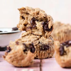 pb banana baked oatmeal cups opened up on pink surface.