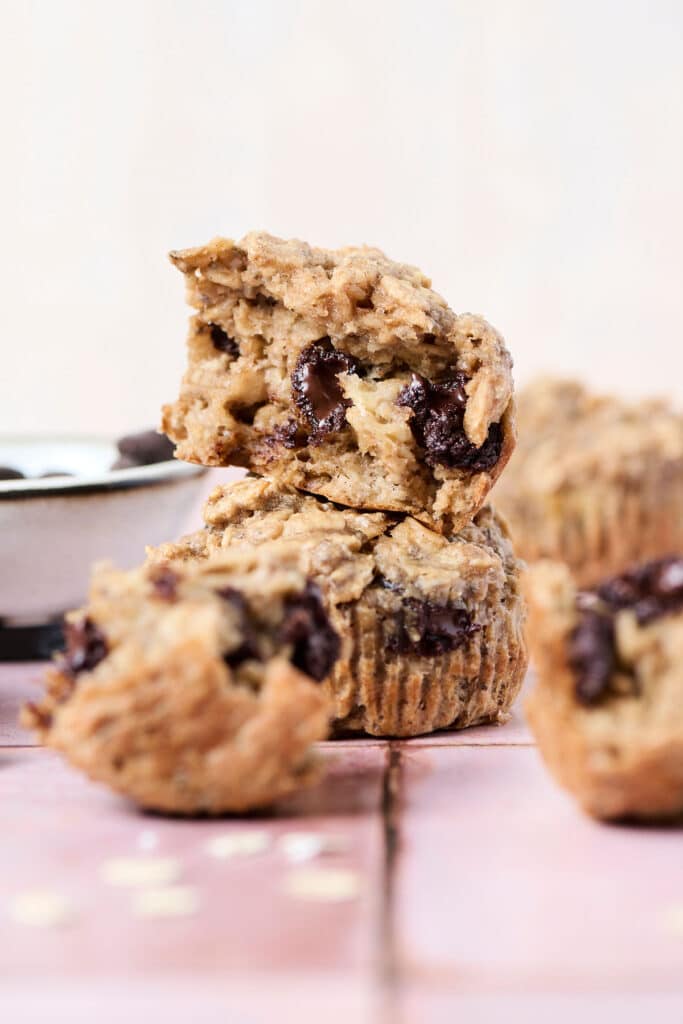 pb banana baked oatmeal cups opened up on pink surface.