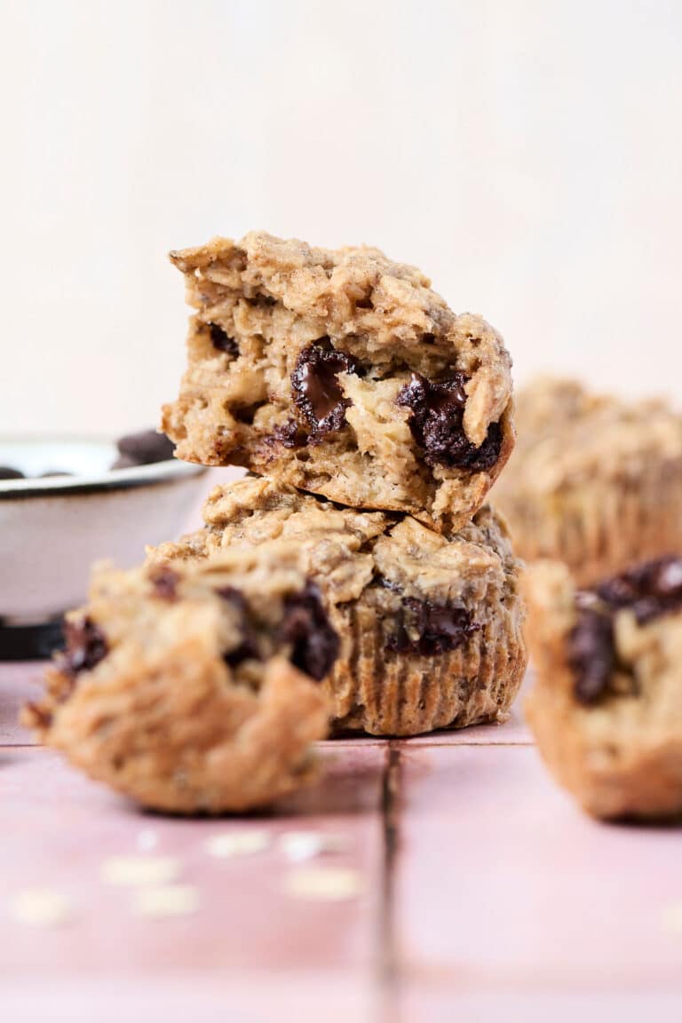 pb banana baked oatmeal cups opened up on pink surface.
