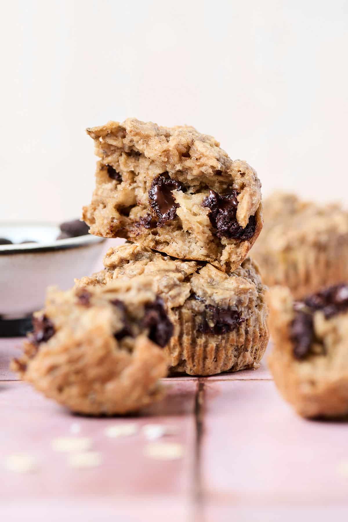 pb banana baked oatmeal cups opened up on pink surface.