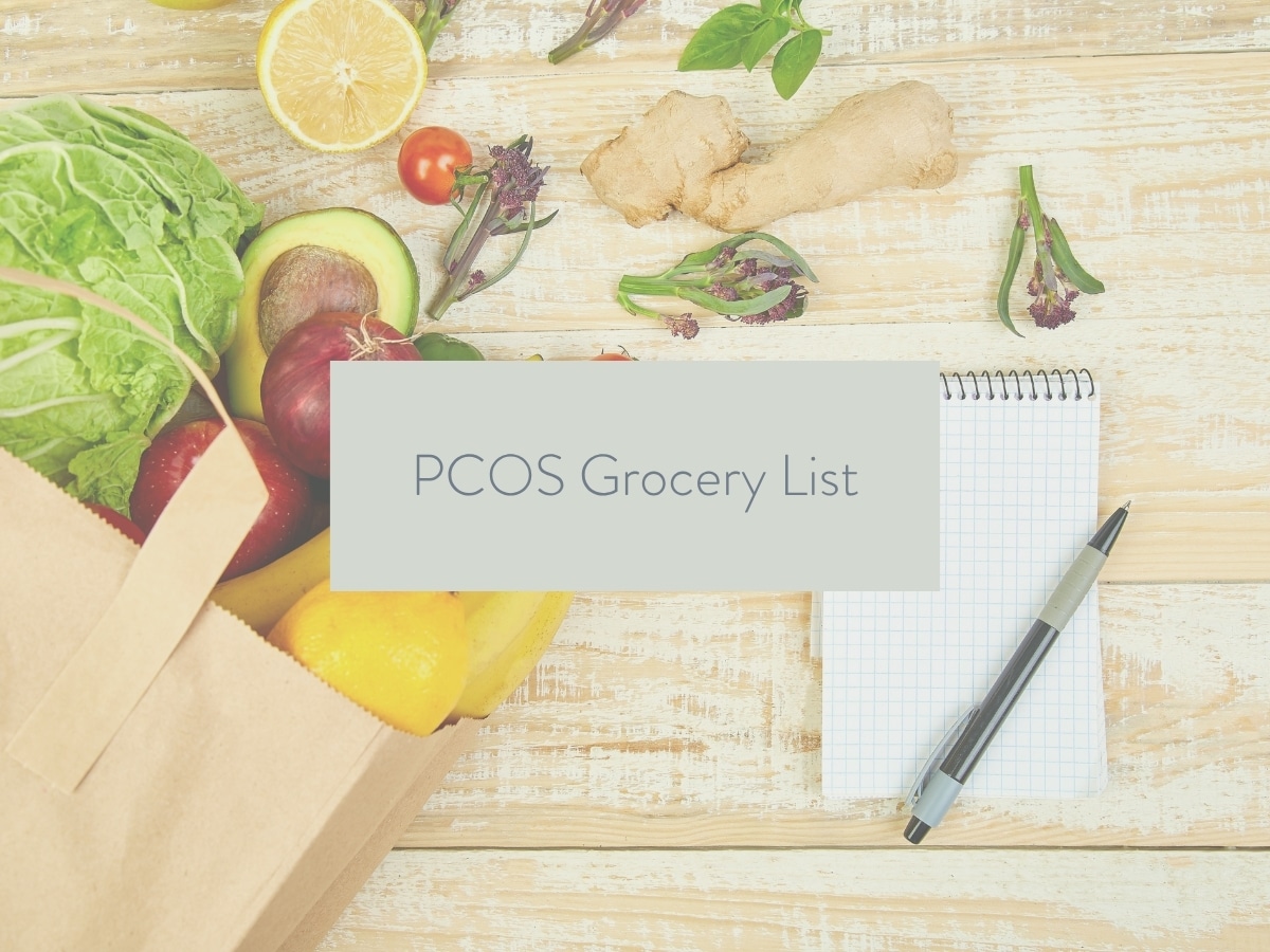 groceries on a wood countertop with a shopping list next to it; text overlay states: PCOS Grocery list.