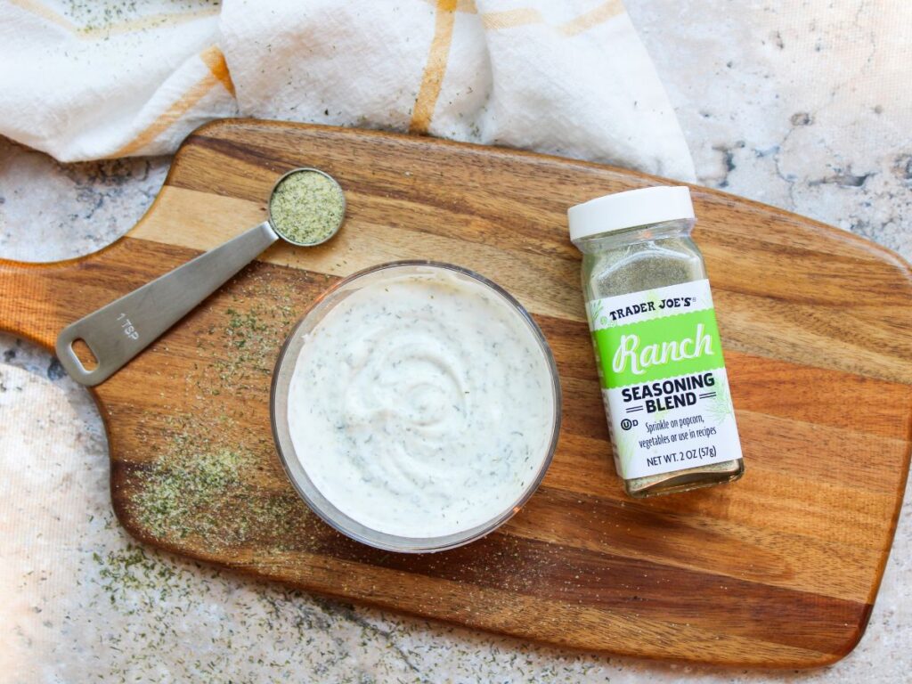 2 ingredient ranch dip on a cutting board with Trader Joe's ranch seasoning beside it