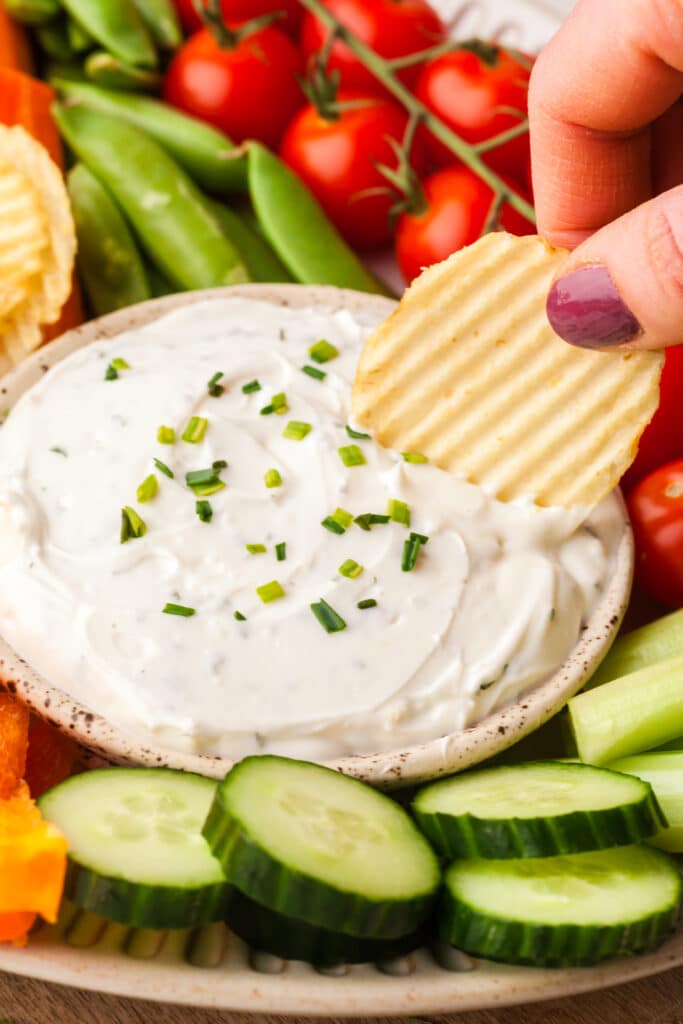 2-ingredient ranch dip with a chip being hand dipped in.