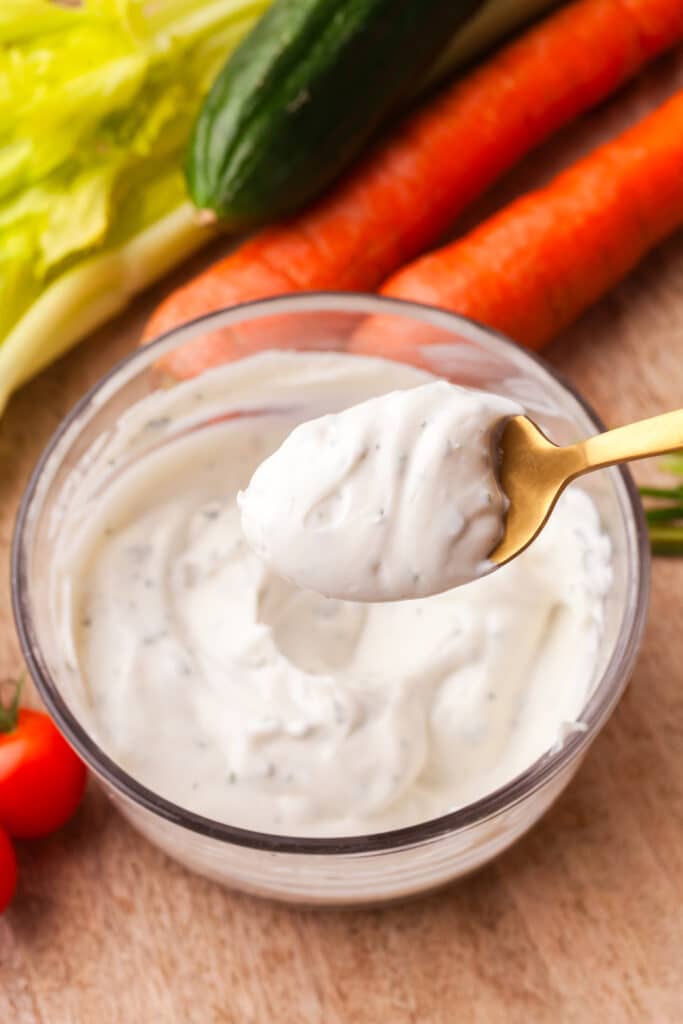 2 ingredient ranch dip in a bowl with some on a gold spoon.