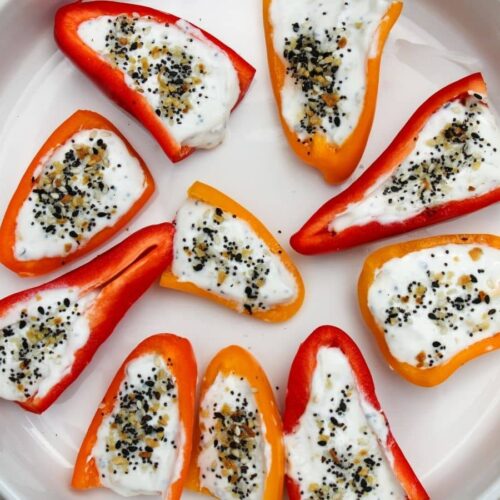 Mini sweet bell peppers cut open and stuffed with a greek yogurt mixture topped with everything bagel seasoning