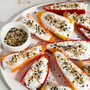 stuffed mini sweet peppers with seasoning on a white plate.