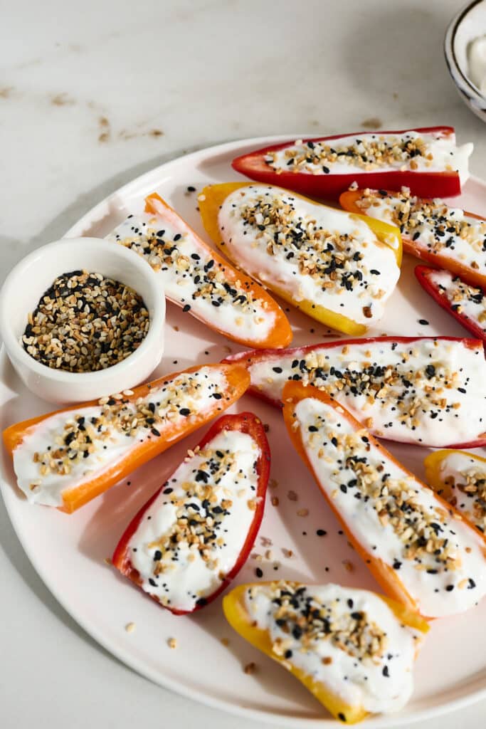 stuffed mini sweet peppers with seasoning on a white plate.