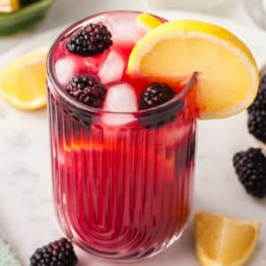 cortisol cocktail with blackberry and lemon garnish in a glass.
