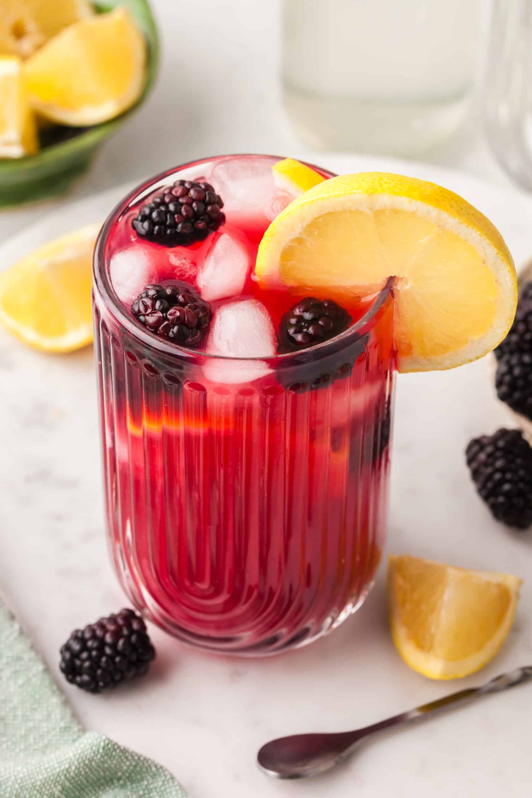 cortisol cocktail with blackberry and lemon garnish in a glass.