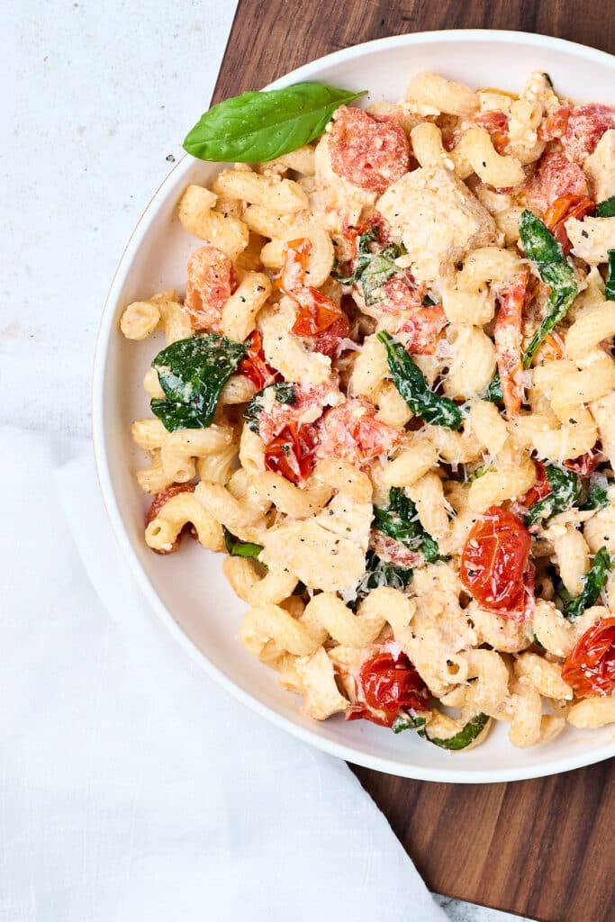 closeup of feta pasta in a white bowl.