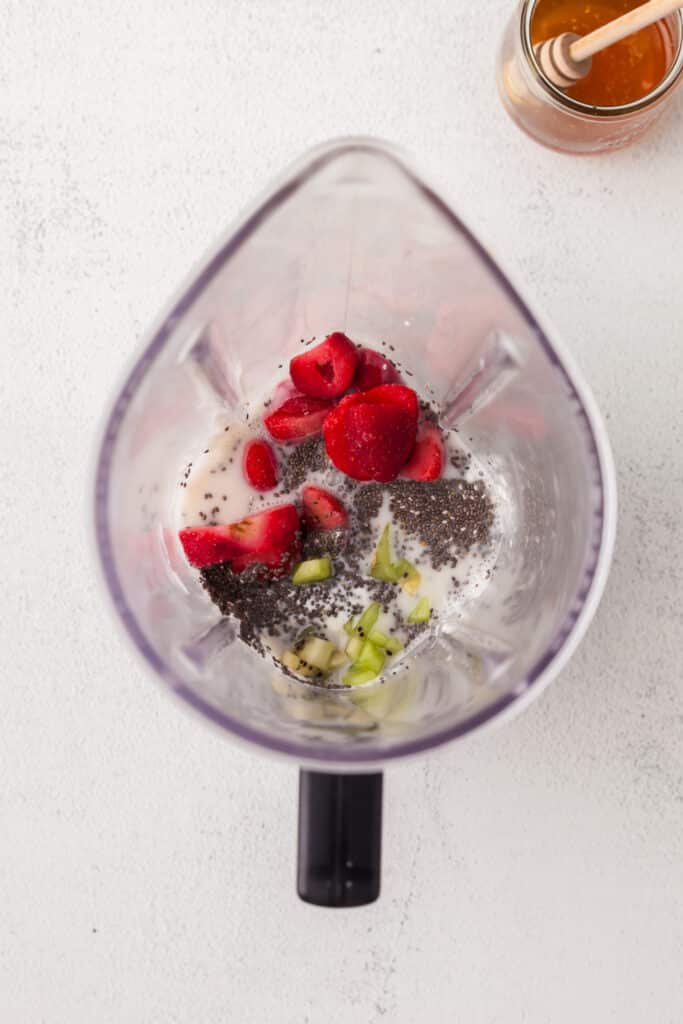 raw smoothie ingredients in a blender before blending.