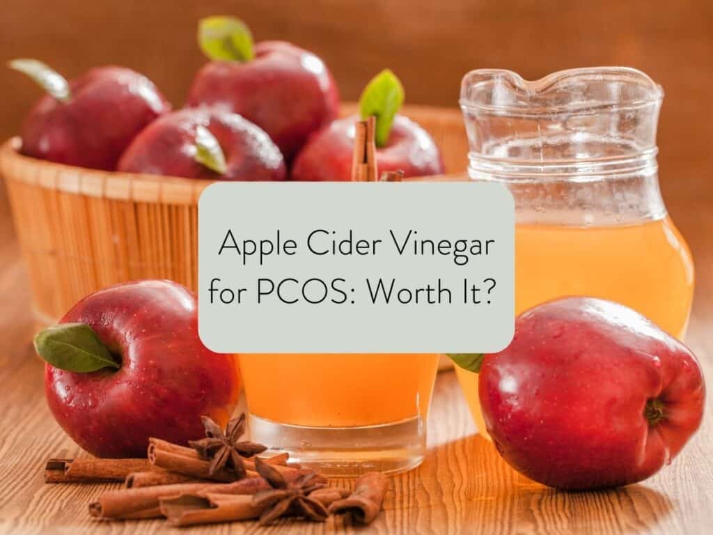 apples in a bowl and on a countertop with a small glass pitcher of apple cider vinegar; text overlay states apple cider vinegar for pcos: worth it?