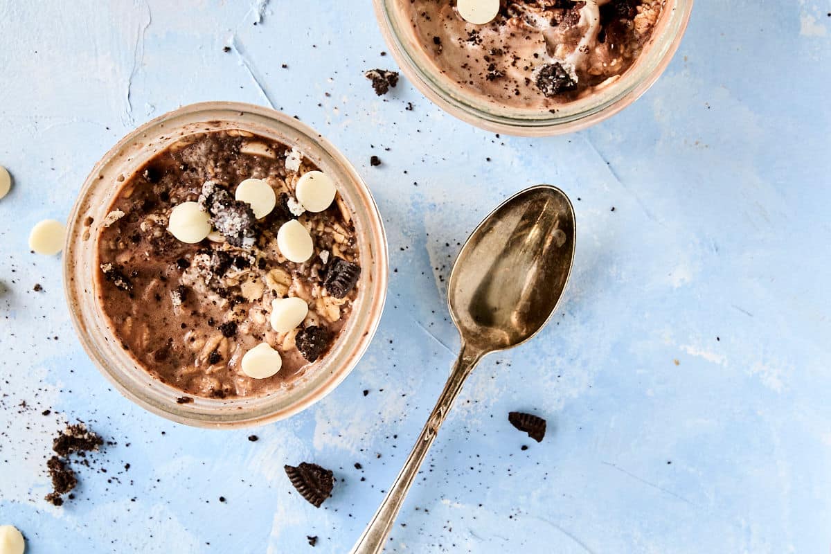 overhead view of cookies and cream overnight oats recipe with a gold spoon and crumbled oreos beside it.