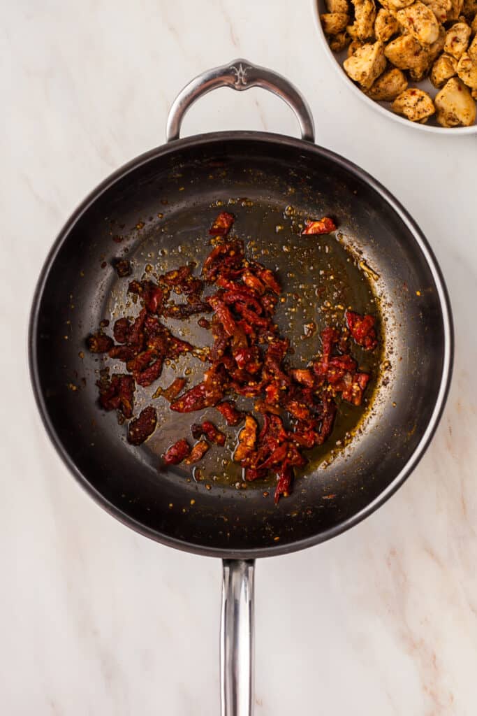 sauted sun-dried tomatoes in a skillet.