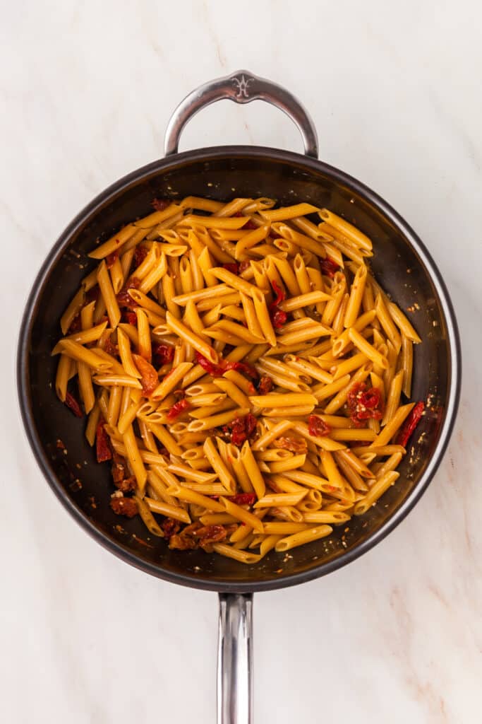sun-dried tomatoes and pasta in a skillet.