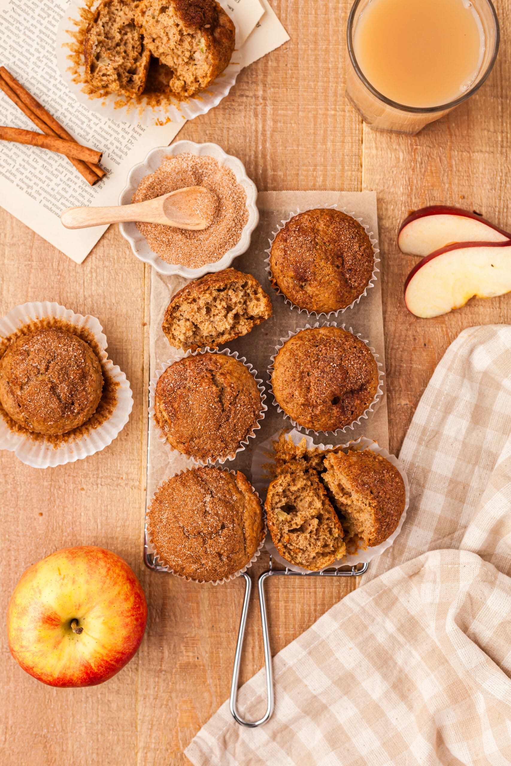 apple cider muffins with ingredients surrounding them.