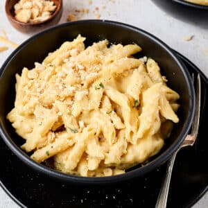 high protein mac and cheese recipe in a black bowl.