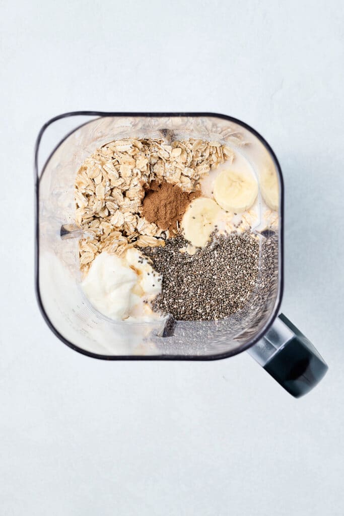 ingredients for blended overnight oats in a blender before being blended.