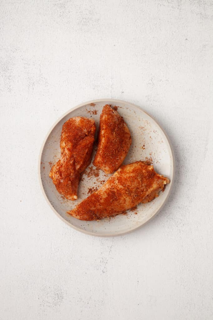 raw chicken seasoned in spices.