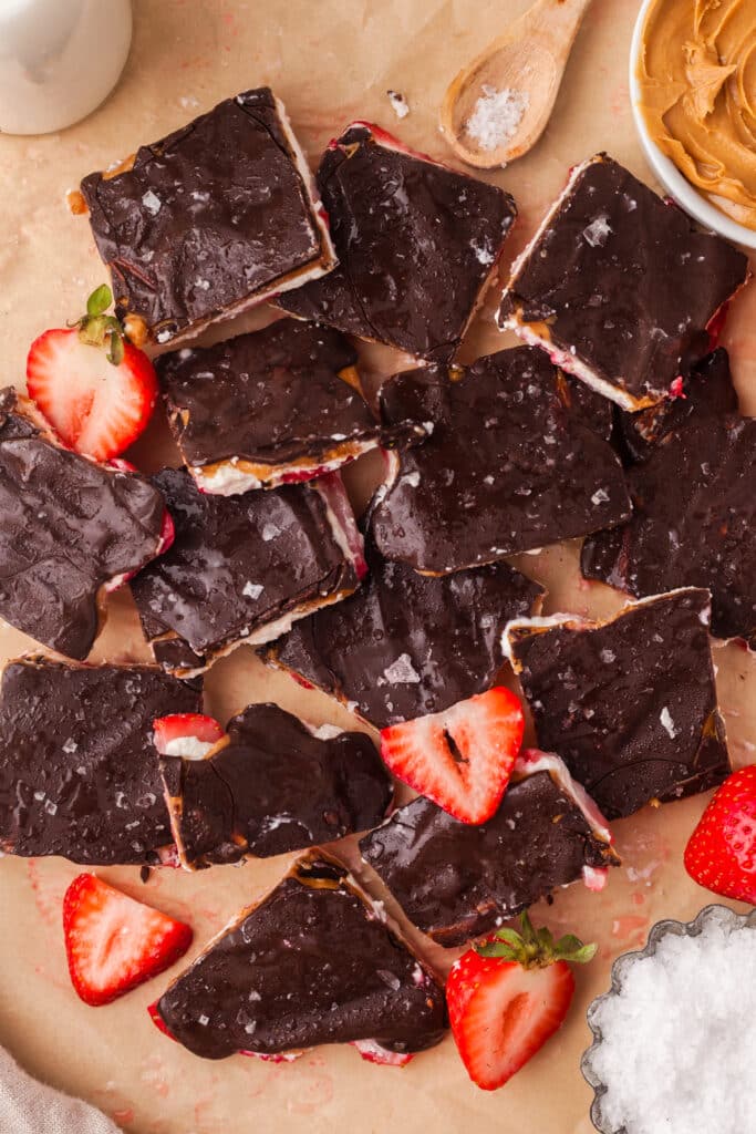 closeup of cut pieces of frozen cottage cheese bark with decorative strawberry slices.