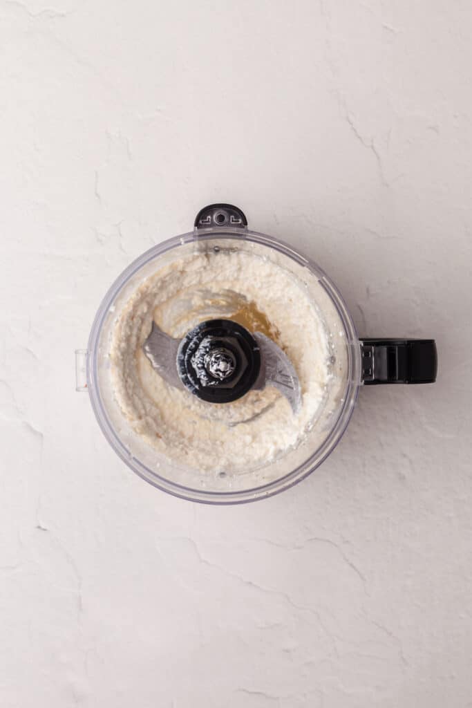 overhead view of cottage cheese in a food processor.