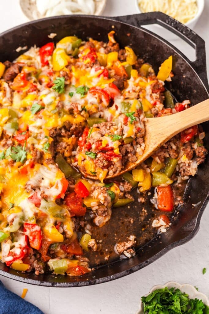 closeup of unstuffed peppers recipe with wooden spoon.