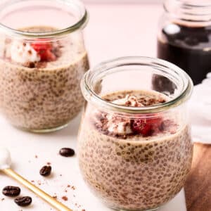 cold brew coffee chia seed pudding in glass jars on a cutting board.