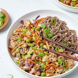 egg roll ground turkey bowls with soba noodles and chopsticks.