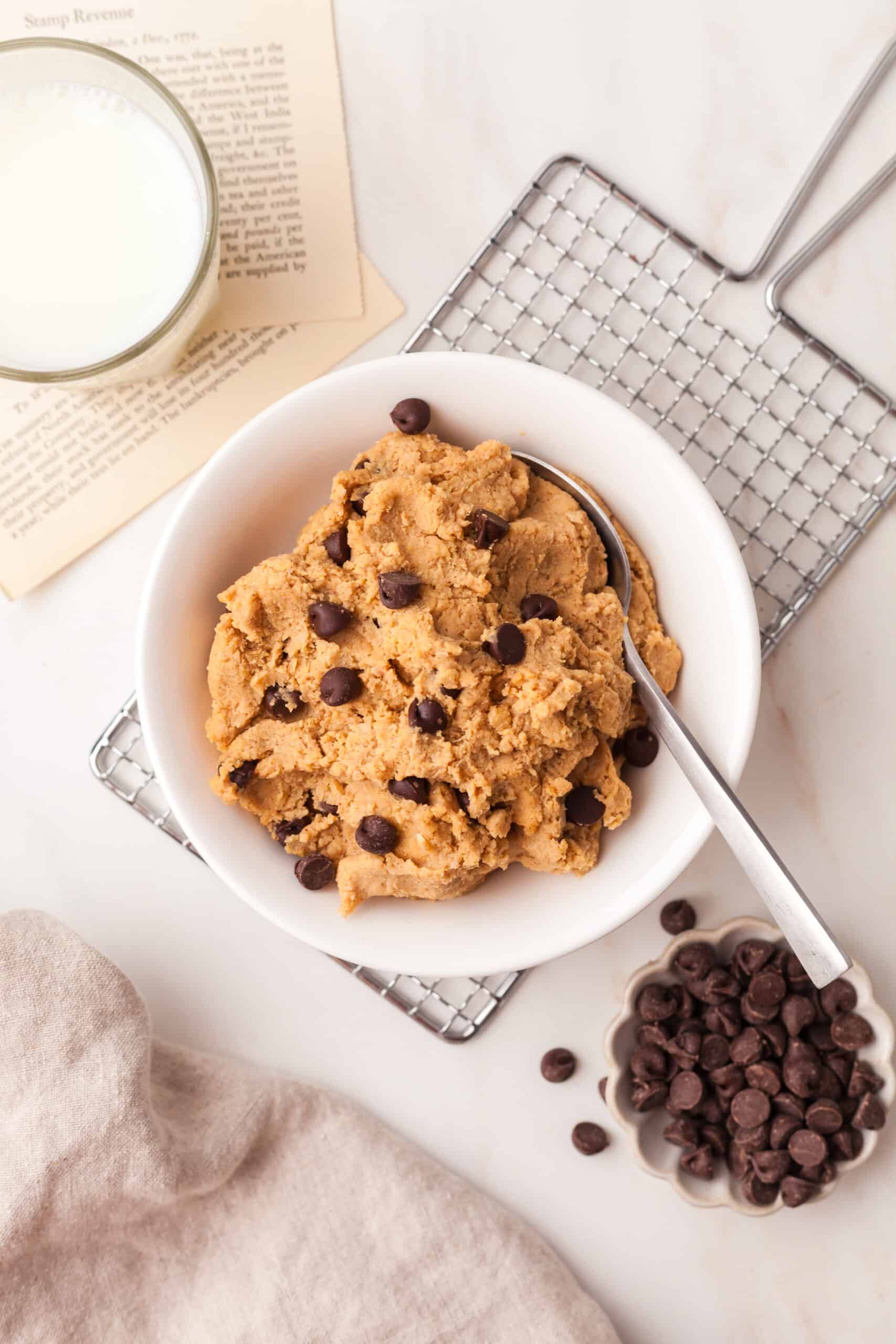 chickpea cookie dough in a white bowl with spoon.