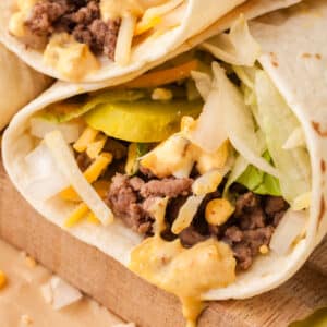 big mac wrap with sauce dripping out.