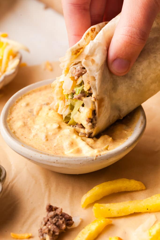 big mac wrap being dipped into big mac sauce.