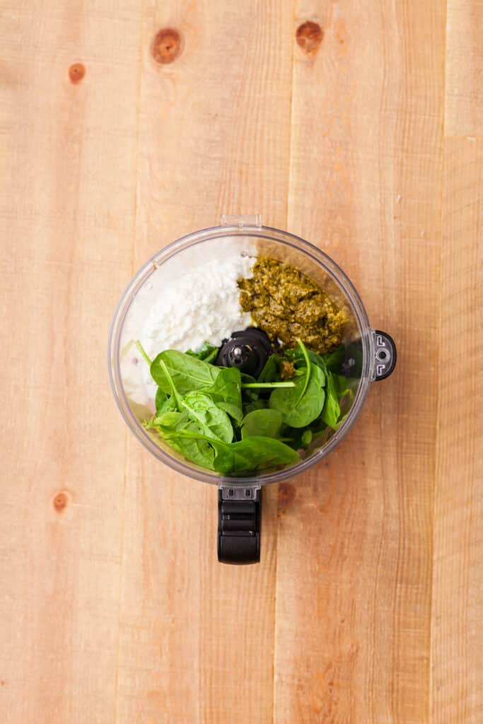 spinach and other ingredients in a food processor.