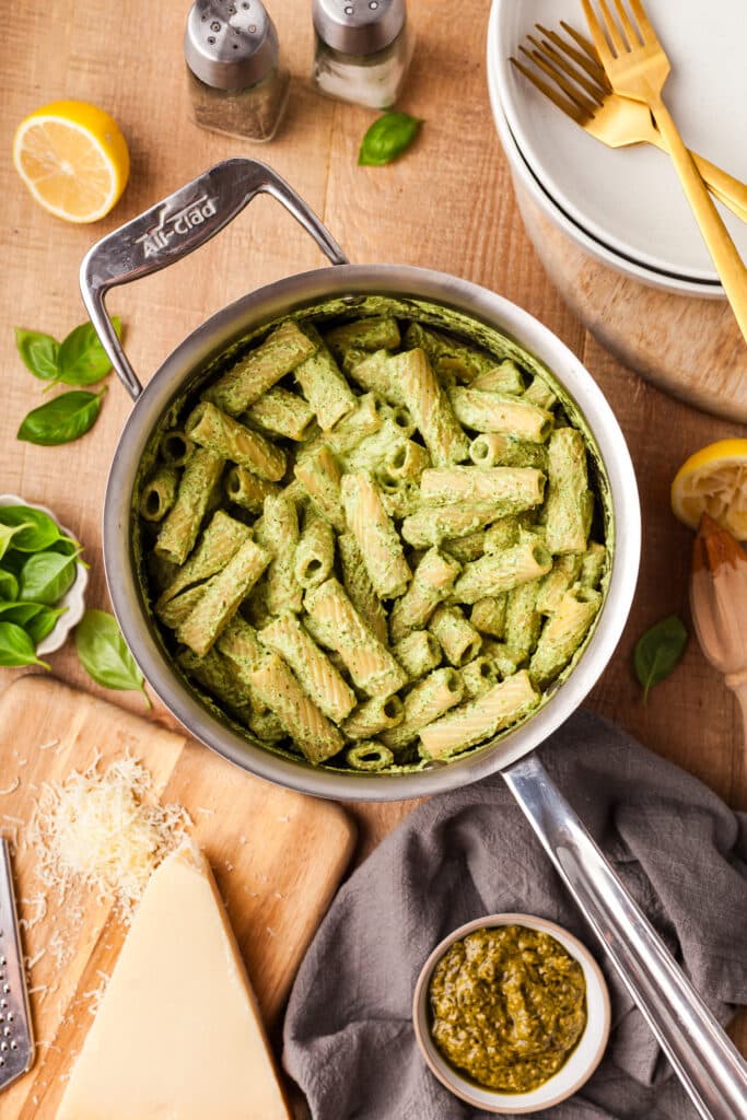 protein pesto pasta in sauce pan on wooden