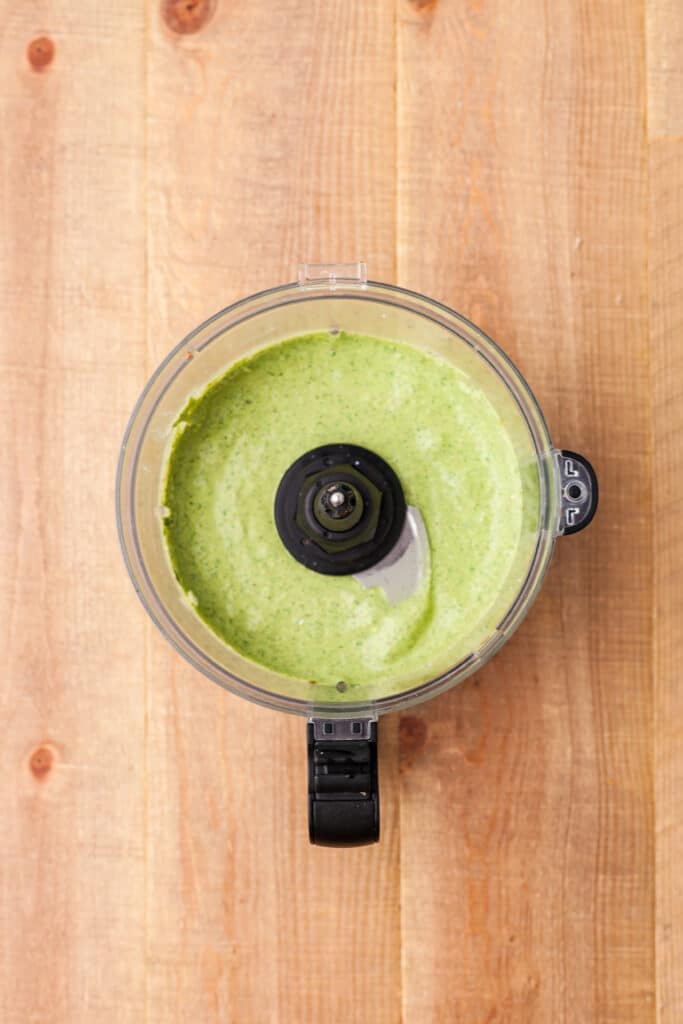 blended creamy pesto sauce in food processor.