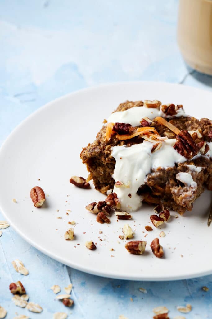 carrot cake baked oats serving on a white plate.