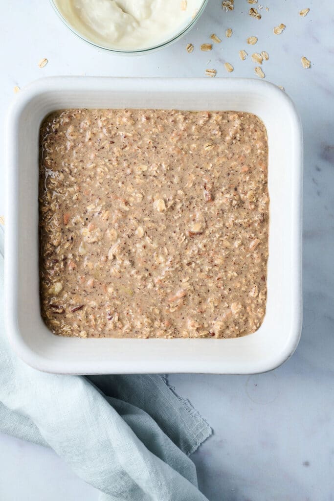 baked oats mixture in a baking dish before being baked.