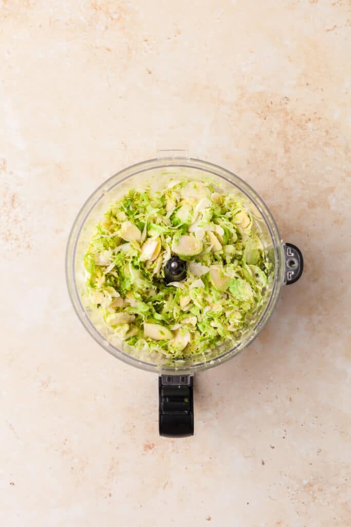 shaved brussels sprouts in a food processor.
