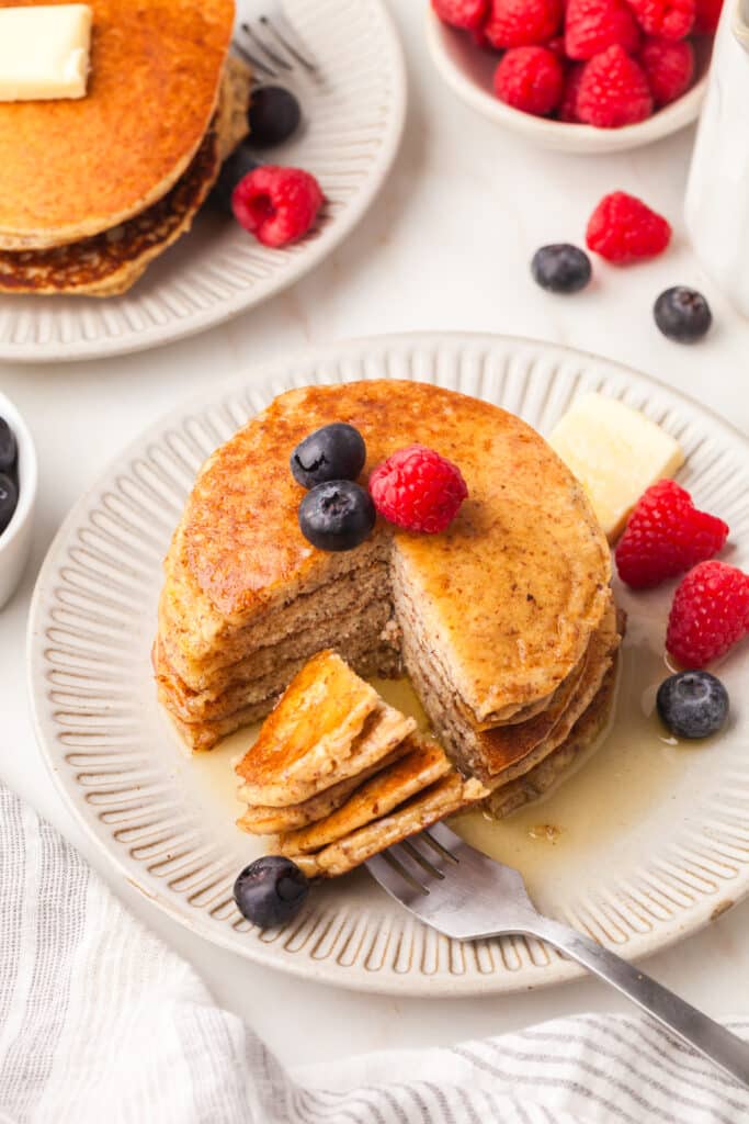 overhead of pcos pancakes stack with one quarter cut out on a fork.