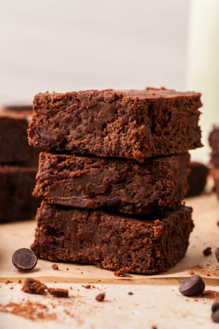 pcos brownies stacked on top of parchment paper.