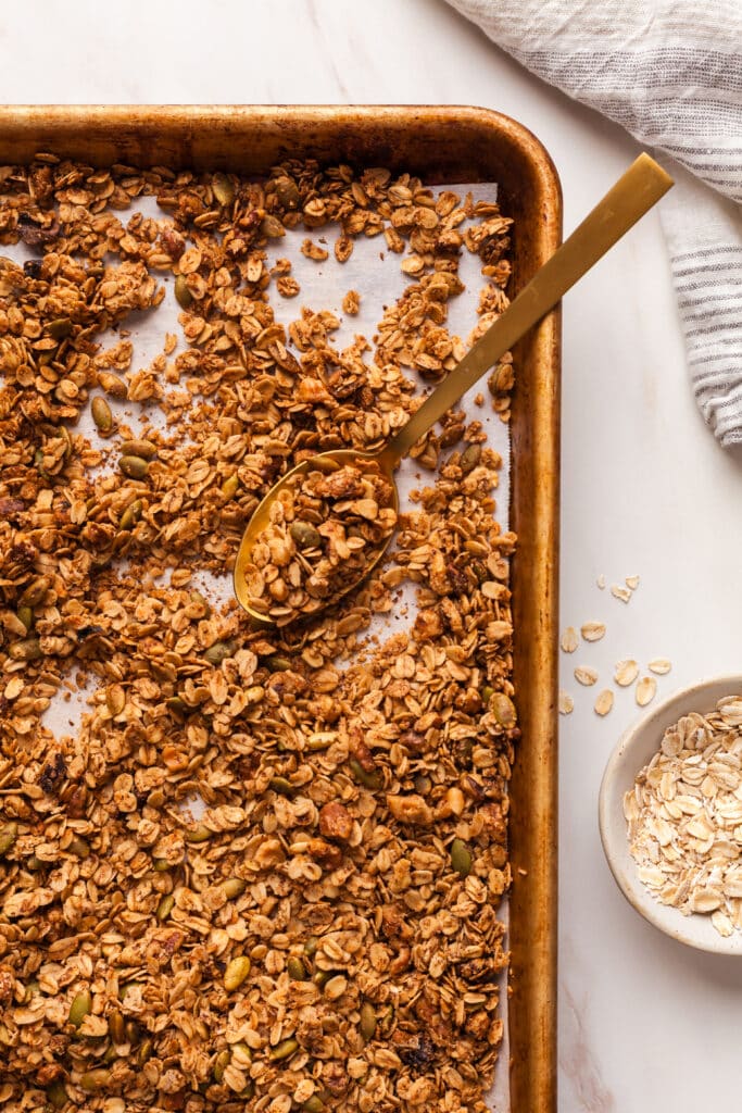 cooked homemade granola on a baking sheet.