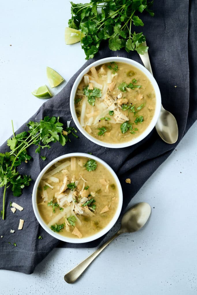 overhead of white chicken chili in two white bowls.