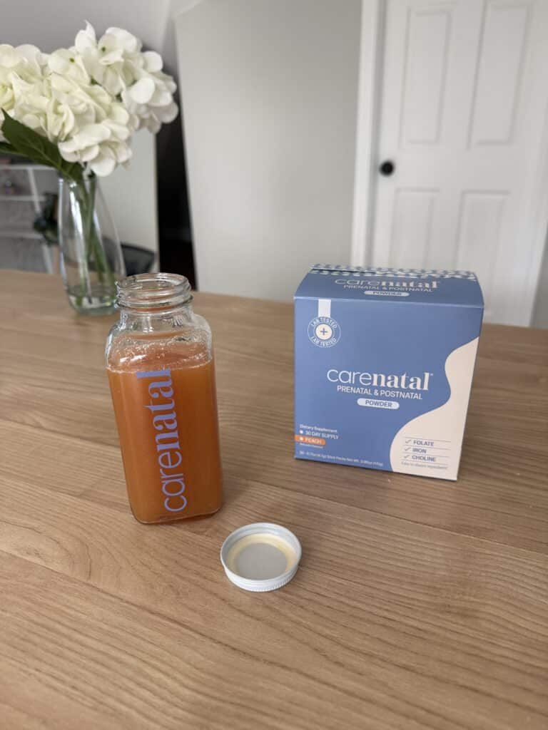 box of carenatal prenatal vitamin powder and mixed up drink on countertop.