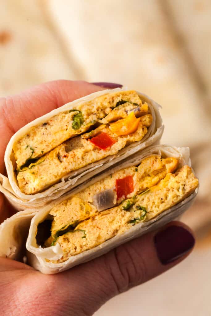 sheet pan egg burrito being held in someone's hand.
