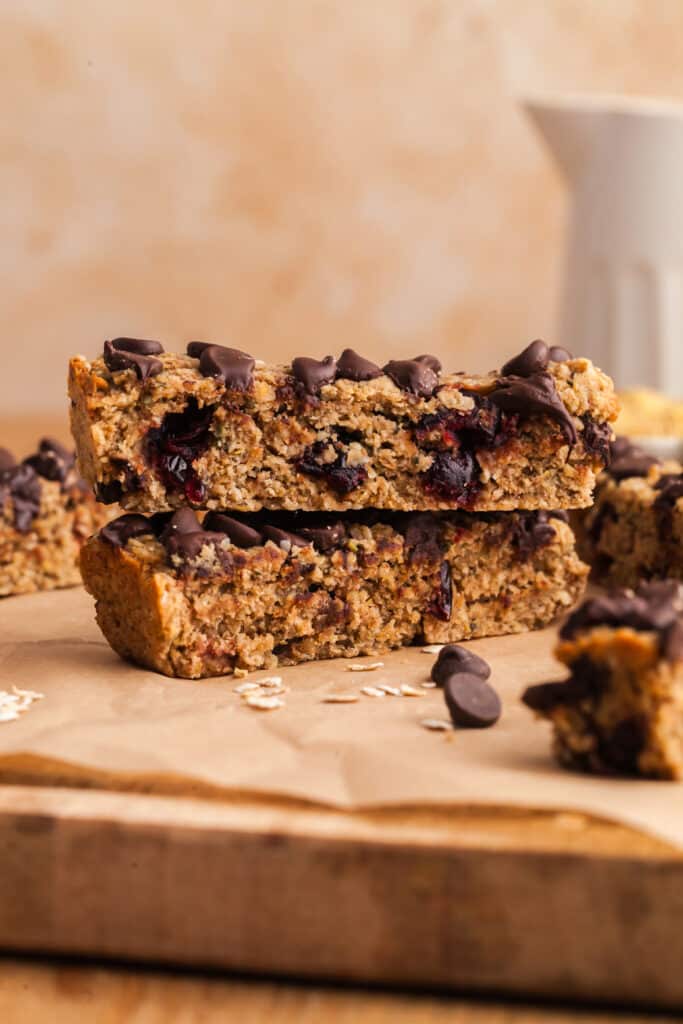 two pcos granola bars stacked on top of each other on parchment paper.