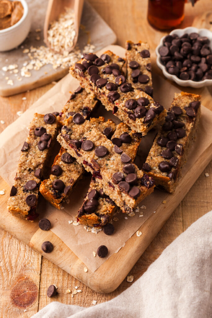 stacked homemade pcos granola bars on parchment paper.