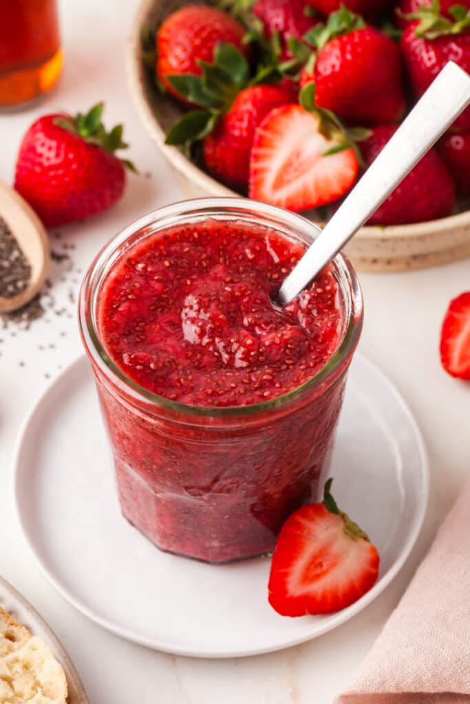 chia seed jam in a mason jar with spoon inserted. 
