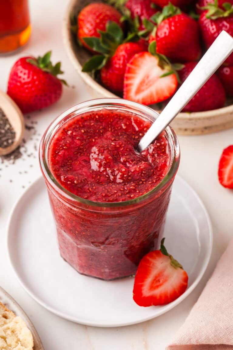 chia seed jam in a mason jar with spoon inserted.