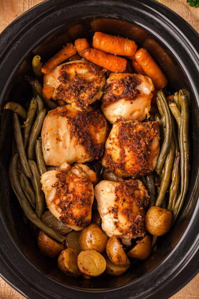 finished chicken, potatoes, and veggies in a crockpot.