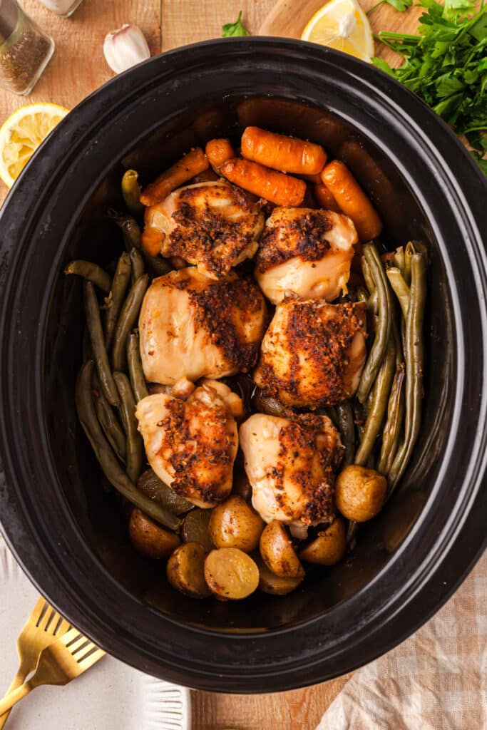 finished chicken, potatoes, and veggies in a crockpot.